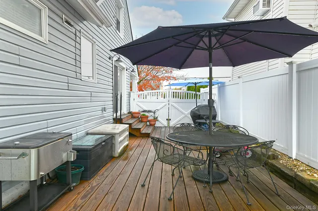 a table and chairs in patio with a barbeque grill