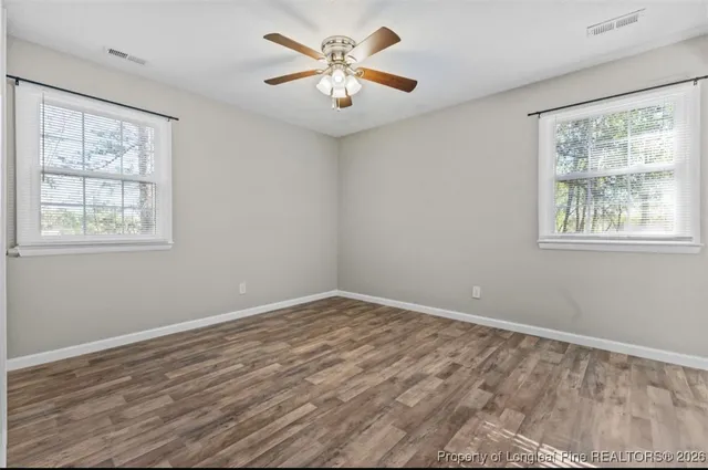 a view of room with window and ceiling fan