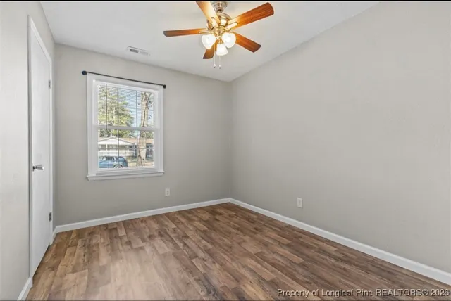 wooden floor in an empty room with a window
