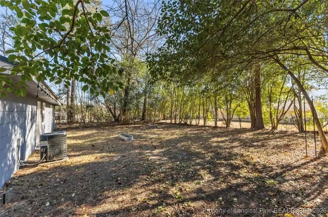 a view of a yard with large trees