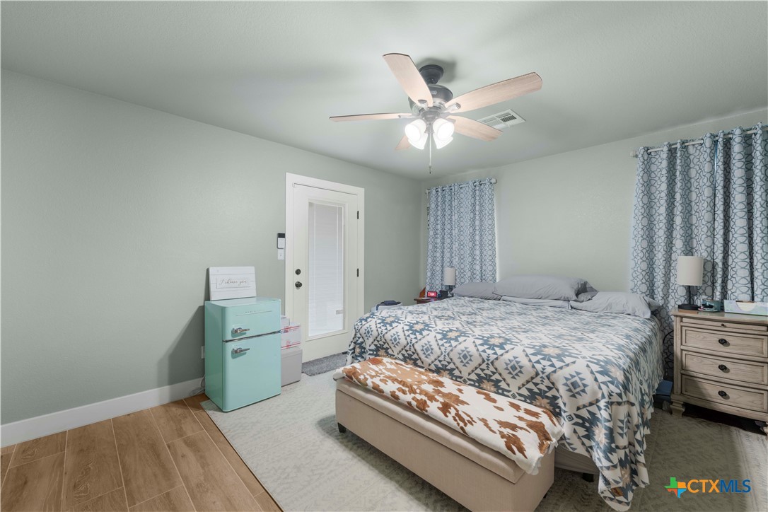 8901 Brewer Lane Salado, TX 76571 - Photo 16 of 30 a bedroom with a bed and a chandelier