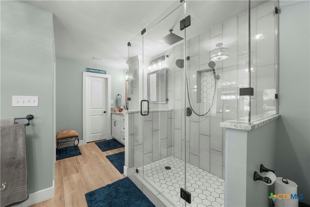 8901 Brewer Lane Salado, TX 76571 - Photo 18 of 30 a bathroom with a glass shower door