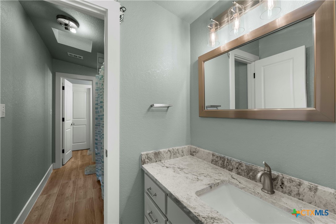 8901 Brewer Lane Salado, TX 76571 - Photo 25 of 30 a bathroom with a sink and a mirror