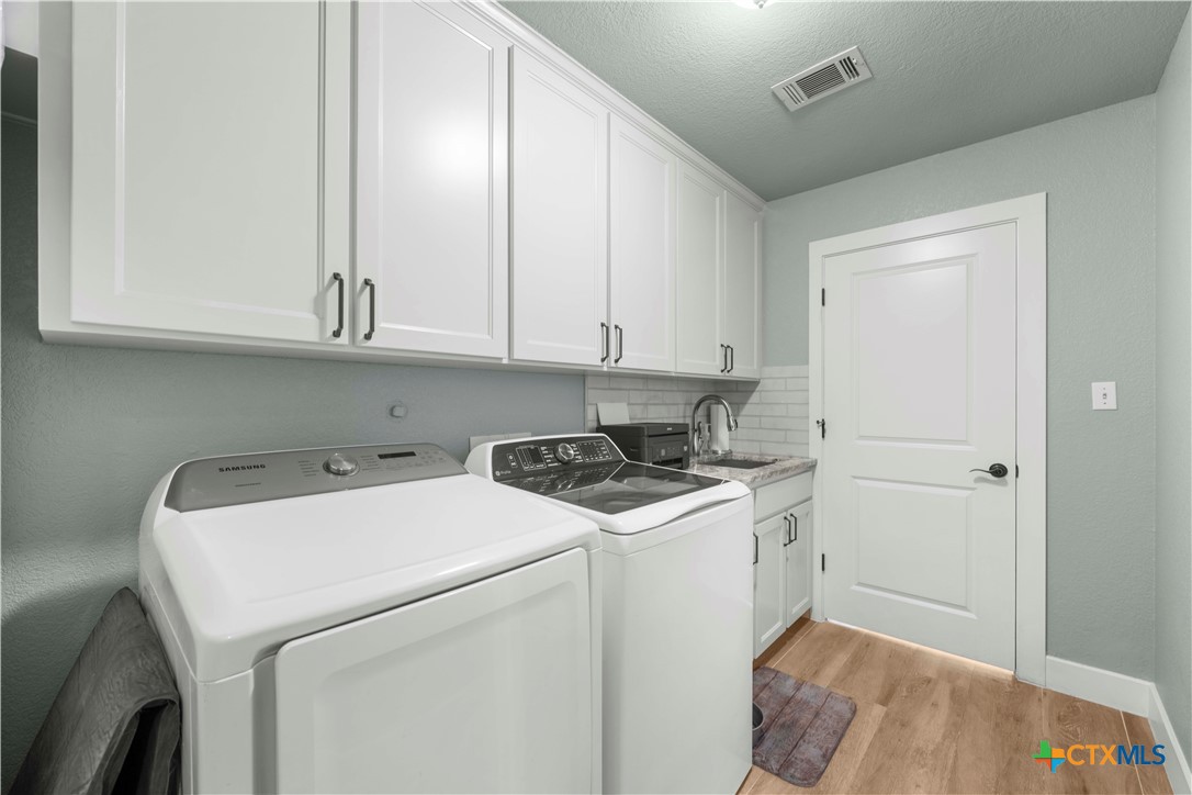 8901 Brewer Lane Salado, TX 76571 - Photo 27 of 30 a view of storage and utility room with washer and dryer