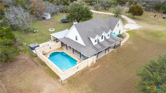an aerial view of a house with a yard