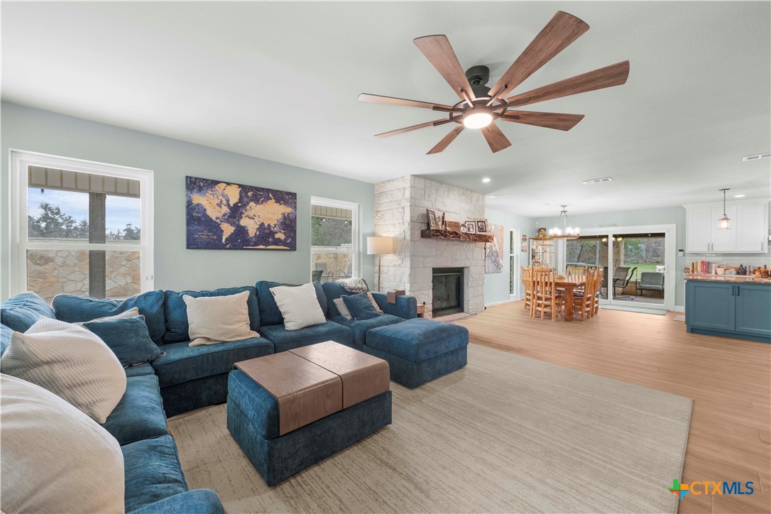 8901 Brewer Lane Salado, TX 76571 - Photo 10 of 30 a living room with furniture a fireplace and a large window
