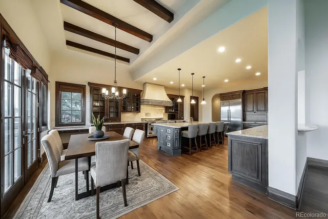 a dining hall with stainless steel appliances kitchen island granite countertop furniture and a kitchen view