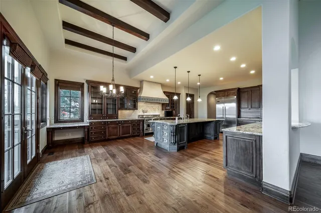 a kitchen with stainless steel appliances kitchen island wooden floors granite top and counter top space