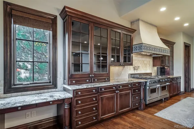 a kitchen with stainless steel appliances granite countertop a stove and a sink