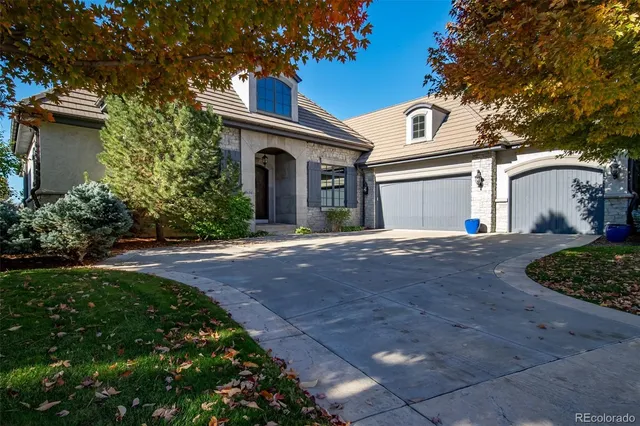 a view of a white house with a yard and plants