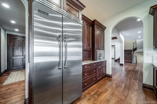 a kitchen with stainless steel appliances granite countertop a refrigerator and a sink