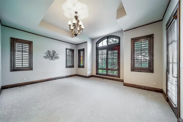 a view of a big room with windows and chandelier