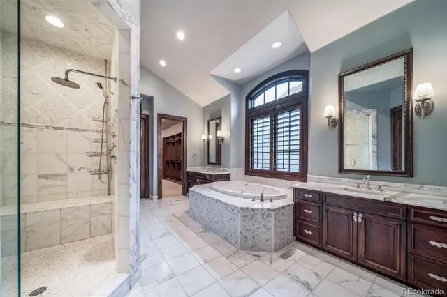 a spacious bathroom with a tub sink and mirror