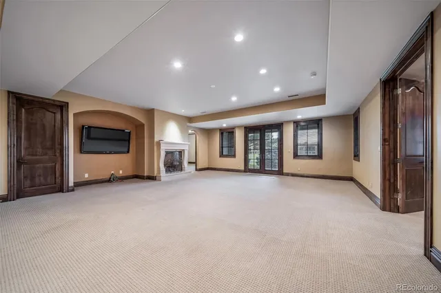 a view of a livingroom with an empty space and fireplace