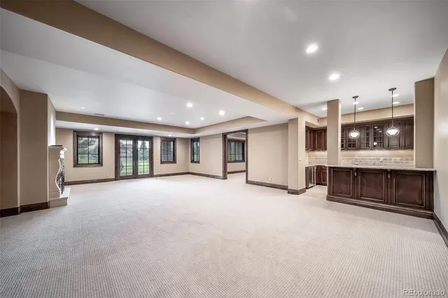 a view of an empty room with a fireplace and window