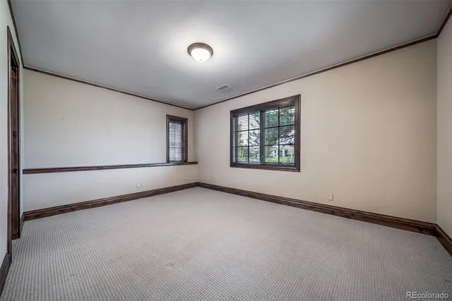 a spacious bathroom with a granite countertop sink a light fixture and a mirror