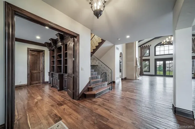 a view of an entryway with wooden floor windows and a livingroom