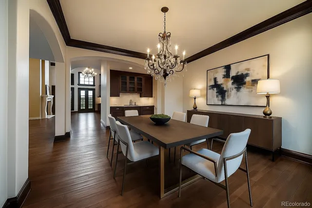 a view of a dining room with furniture wooden floor and a chandelier