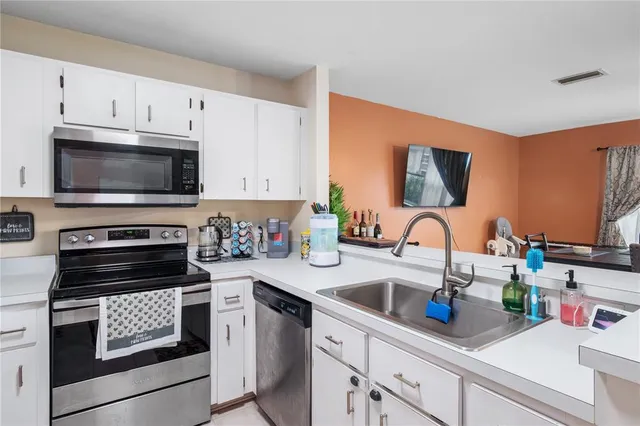a kitchen with a refrigerator stove and microwave