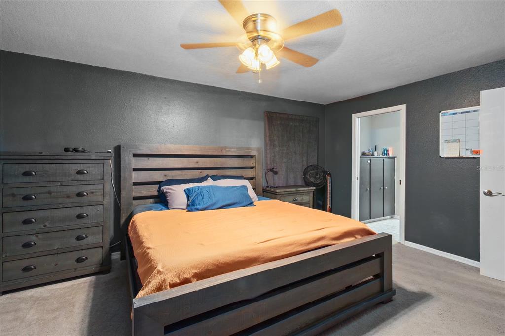 2801 Southwest 167th Lane Ocala, FL 34473 - Photo 22 of 62 a bedroom with a bed and a chandelier