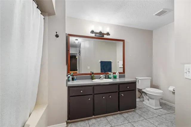 a living room with furniture and a baby crib
