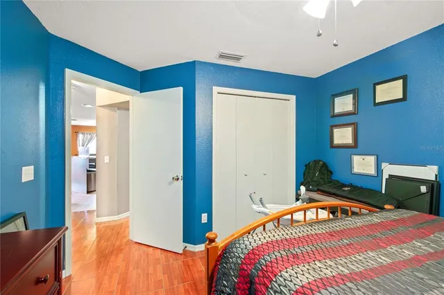 a bathroom with a granite countertop sink and a toilet
