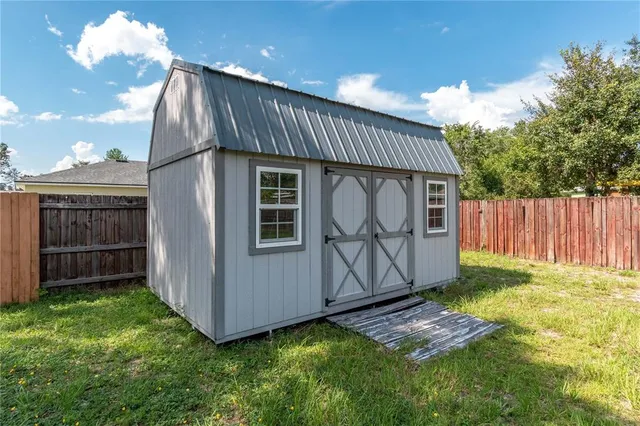 an aerial view of residential houses with outdoor space and parking