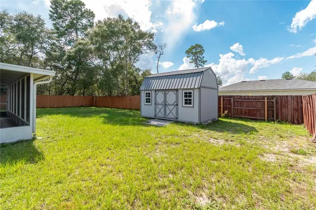 an aerial view of residential houses with outdoor space and swimming pool