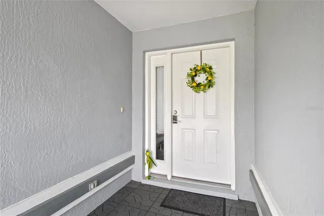 a living room with furniture a flat screen tv and kitchen view