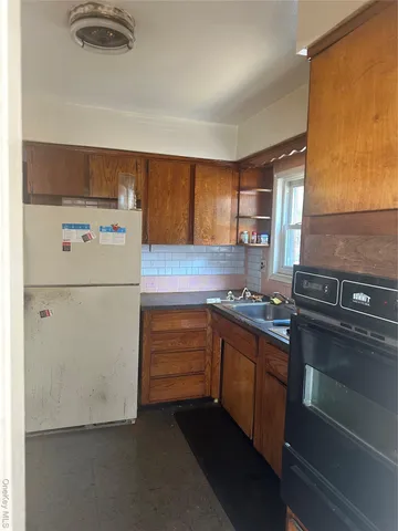 a kitchen with a refrigerator and a sink