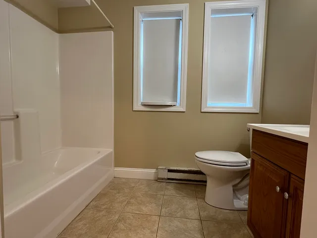 a bathroom with a toilet a sink and bathtub