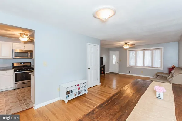 a kitchen with stainless steel appliances a stove a microwave and white cabinets
