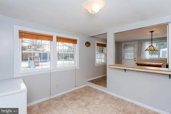 a bedroom with a bed and a flat tv screen on dresser