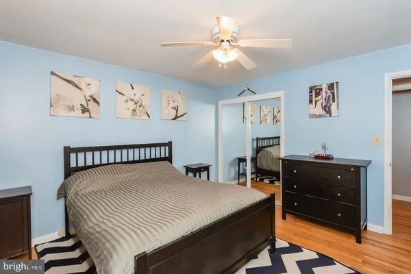 a bedroom with a bed and a table in it with window