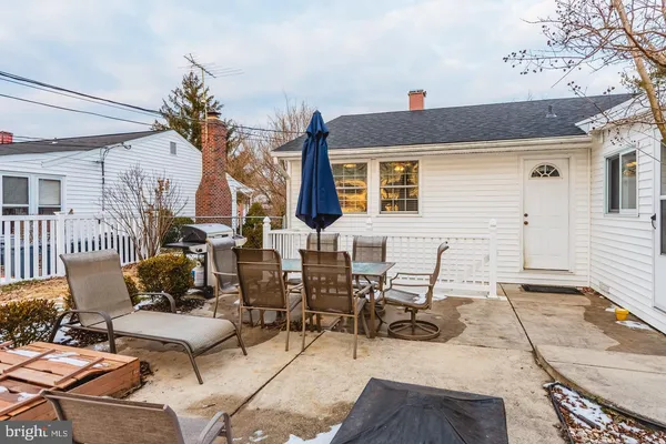 a view of a patio with table and chairs and potted plants