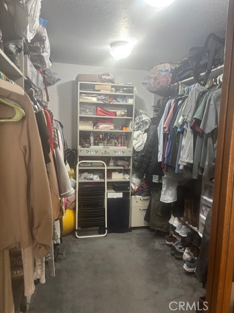 39334 Willowvale Road Palmdale, CA 93551 - Photo 11 of 21 a view of walk in closet with clothes and shoes