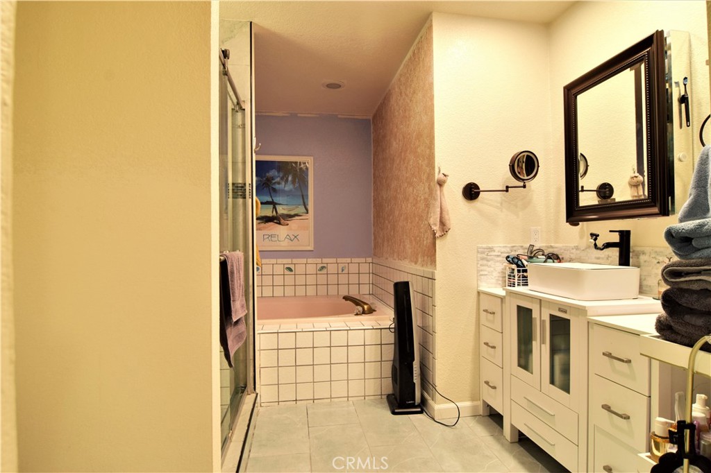 39334 Willowvale Road Palmdale, CA 93551 - Photo 12 of 21 a bathroom with a tub sink and mirror