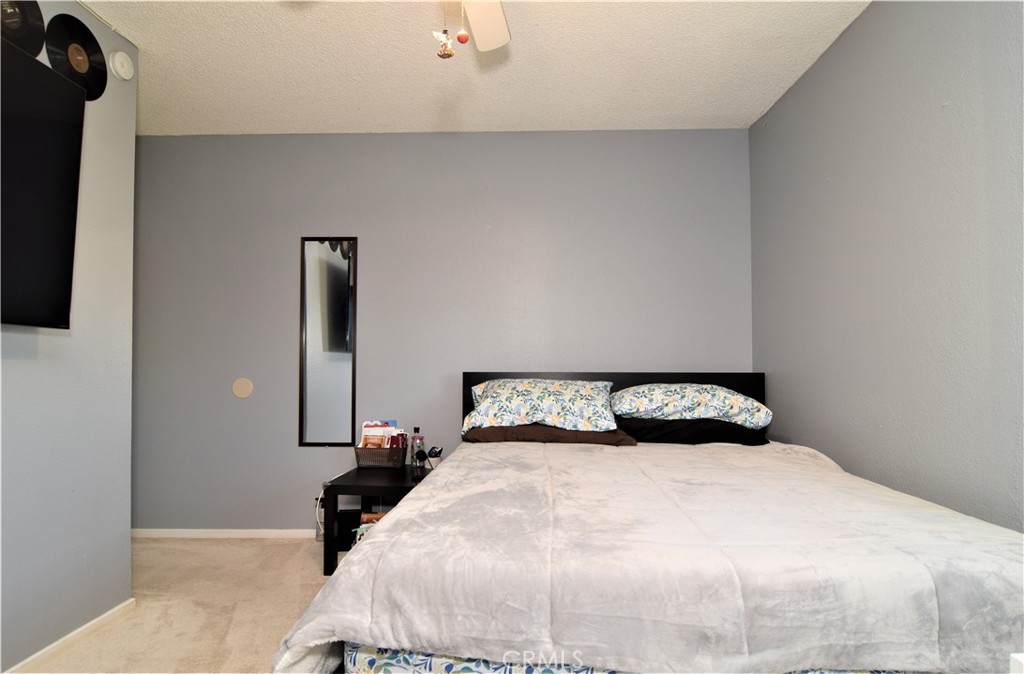 39334 Willowvale Road Palmdale, CA 93551 - Photo 13 of 21 a bedroom with a bed and a flat tv screen on the dresser
