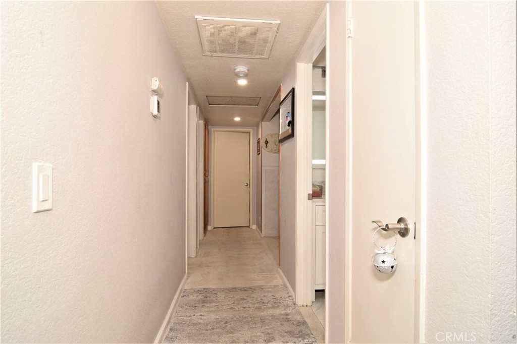 39334 Willowvale Road Palmdale, CA 93551 - Photo 15 of 21 a view of a hallway with wooden floor