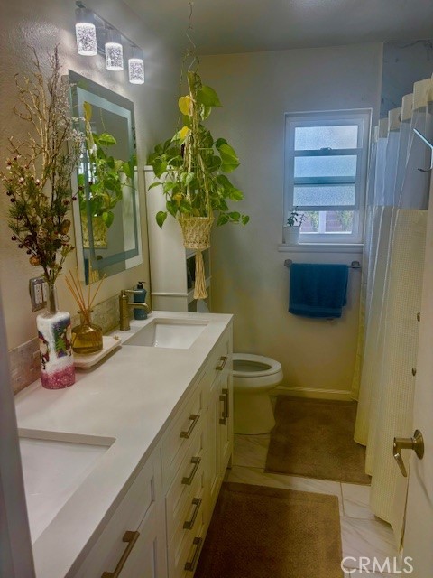 39334 Willowvale Road Palmdale, CA 93551 - Photo 17 of 21 a bathroom with a sink a mirror and a toilet