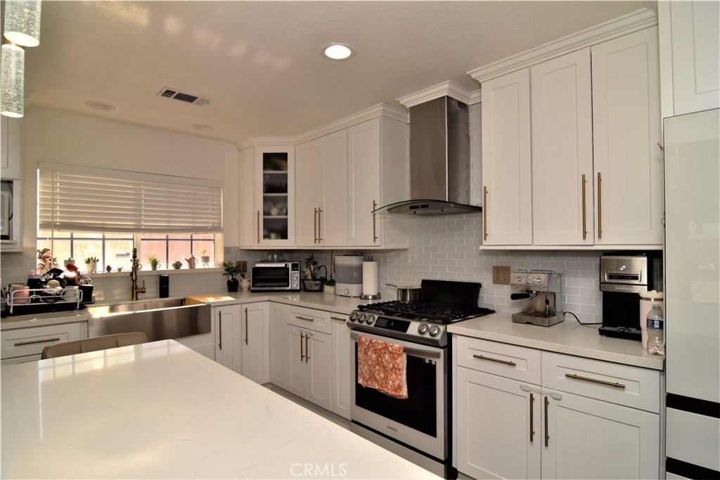 39334 Willowvale Road Palmdale, CA 93551 - Photo 5 of 21 a kitchen with granite countertop a stove sink and cabinets
