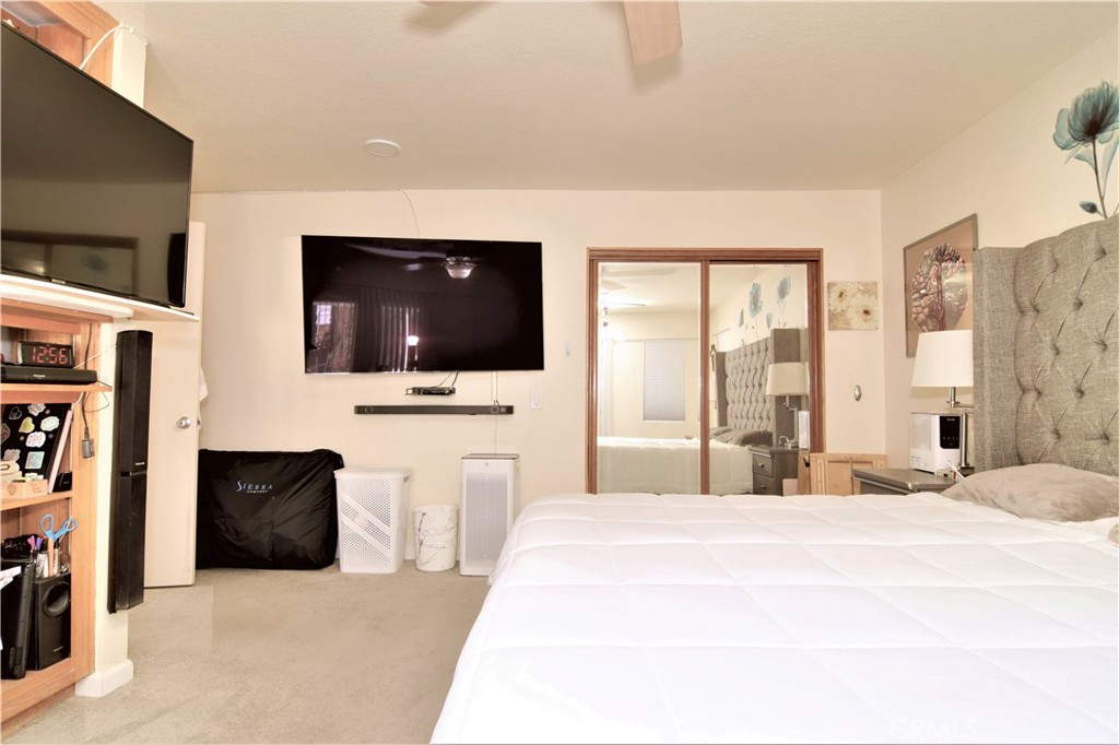 39334 Willowvale Road Palmdale, CA 93551 - Photo 9 of 21 a bedroom with a bed and a flat screen tv
