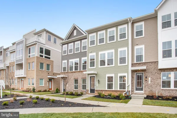 a front view of a residential apartment building with a yard