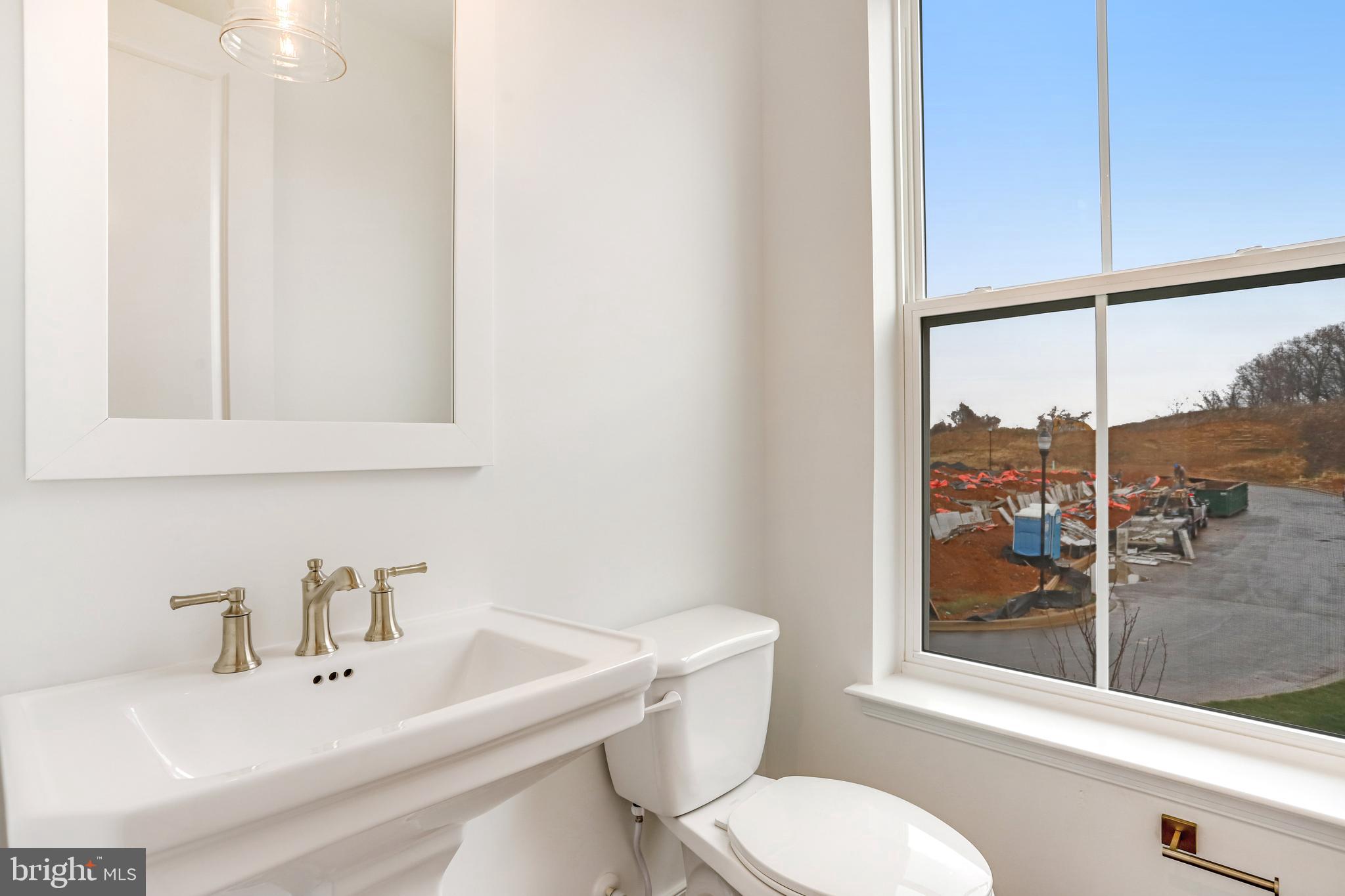1889 Shookstown Road Frederick, MD 21702 - Photo 27 of 47 a bathroom with a sink mirror and toilet