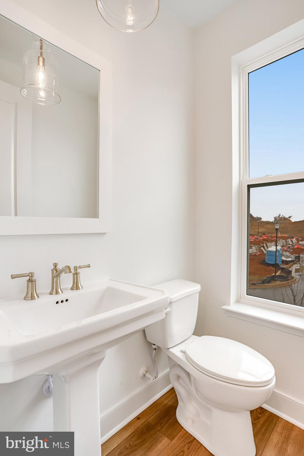 1889 Shookstown Road Frederick, MD 21702 - Photo 28 of 47 a white toilet sitting next to a bathroom sink