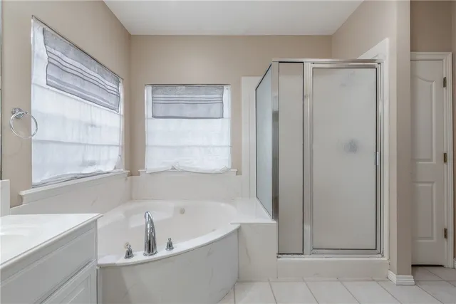 a white bath tub sitting next to a window