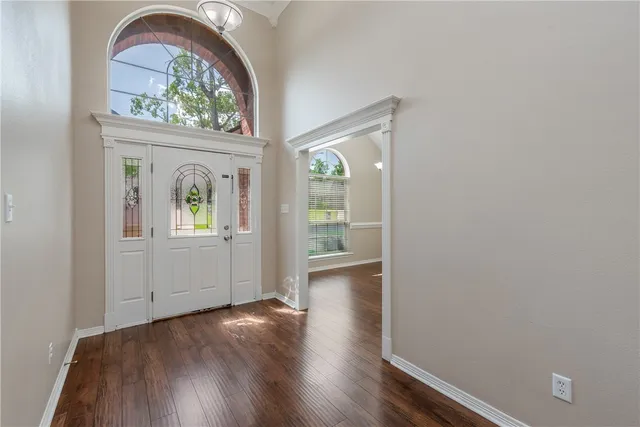 a view of an entryway with wooden floor