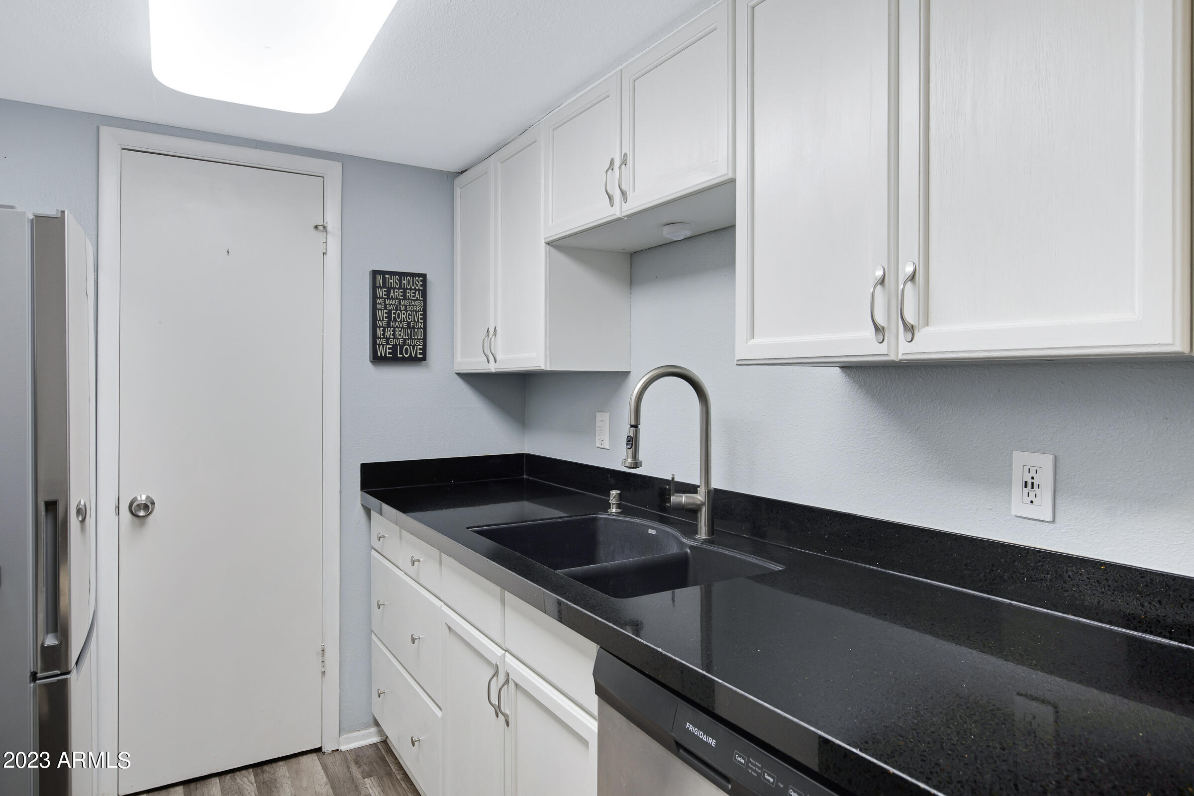 948 South Alma School Road, Unit 147 Mesa, AZ 85210 - Photo 11 of 22 a kitchen with granite countertop white cabinets and a sink