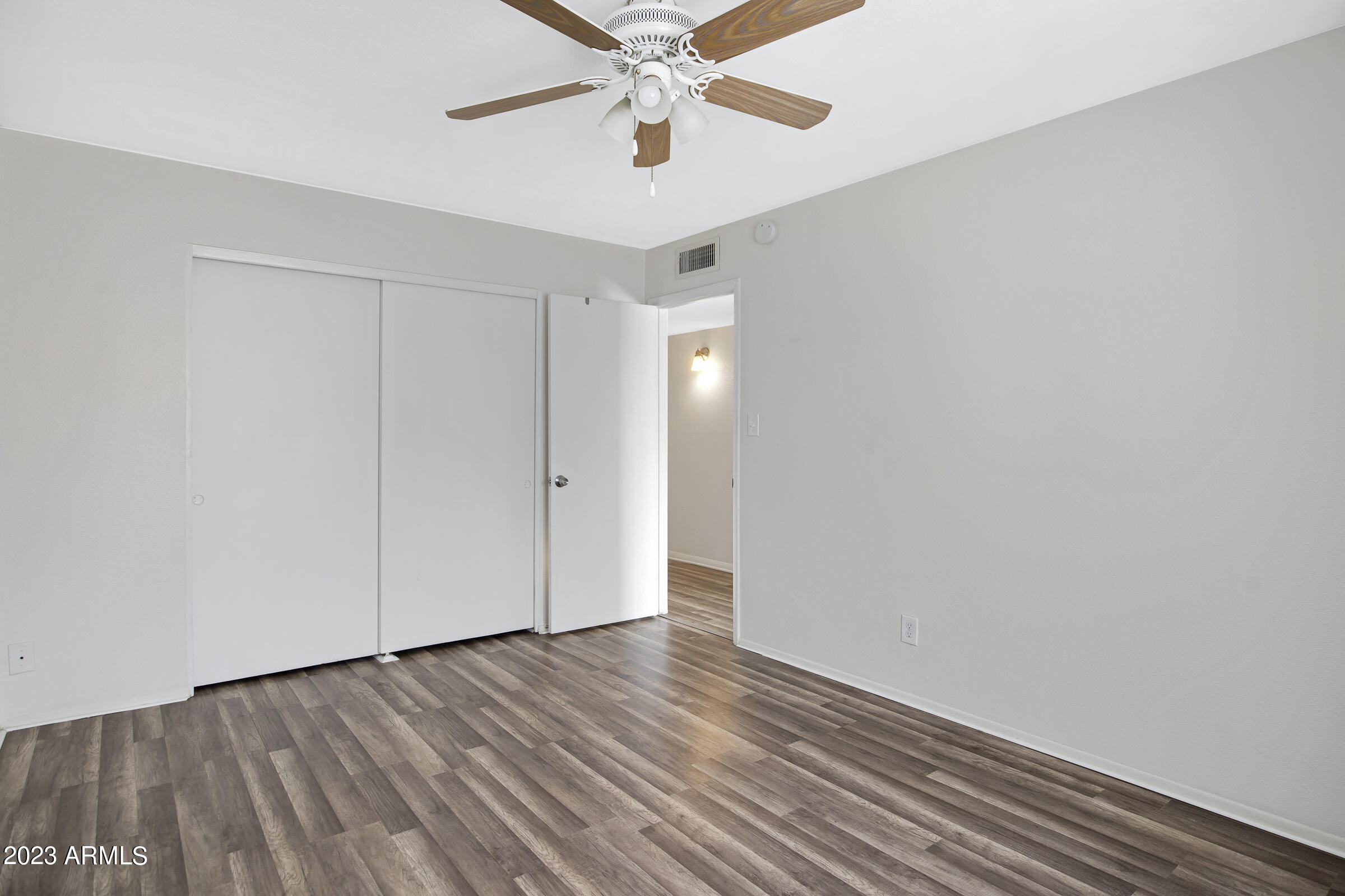 948 South Alma School Road, Unit 147 Mesa, AZ 85210 - Photo 16 of 22 a view of an empty room with wooden floor