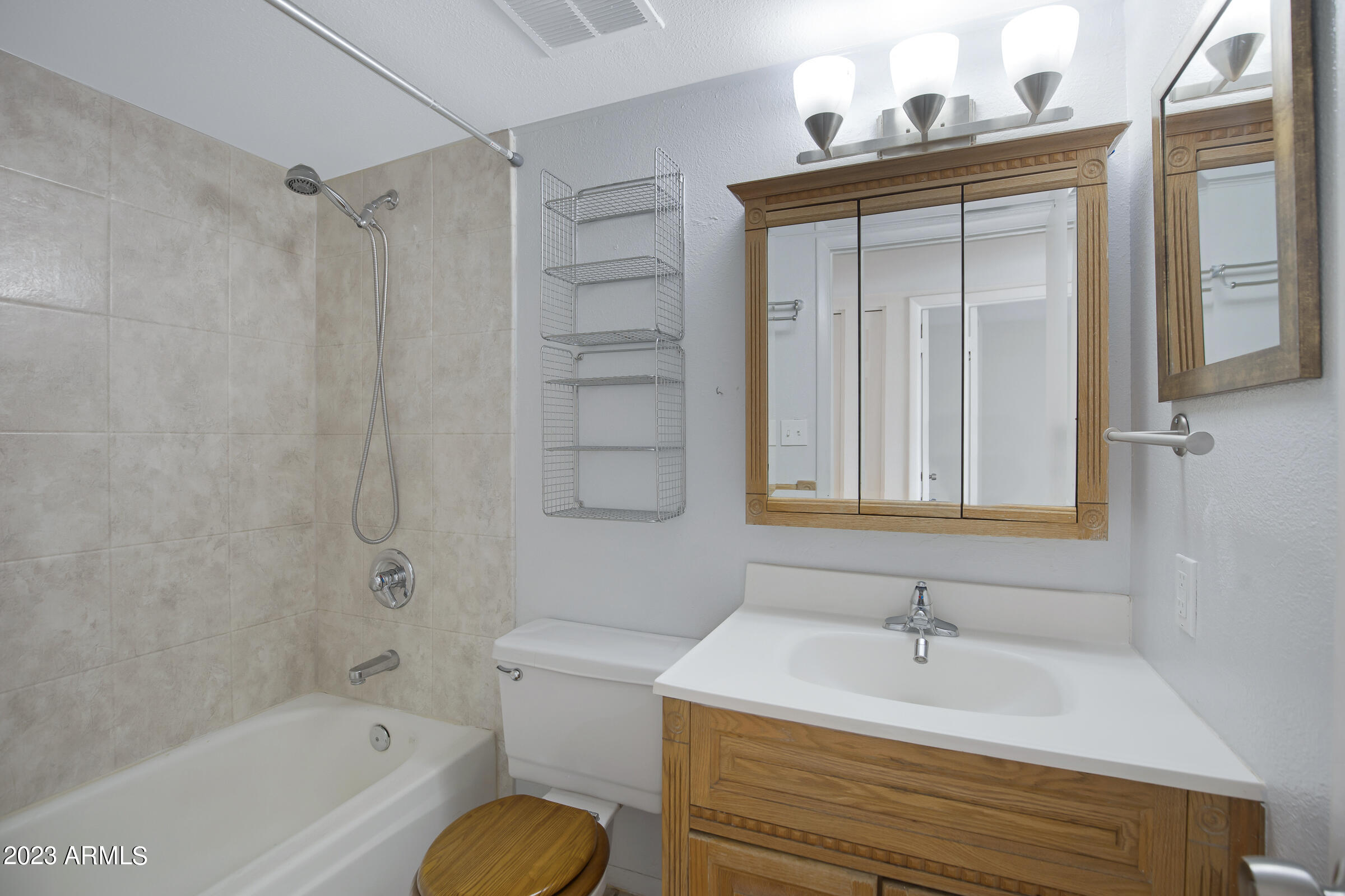 948 South Alma School Road, Unit 147 Mesa, AZ 85210 - Photo 18 of 22 a bathroom with a sink a toilet and a bathtub
